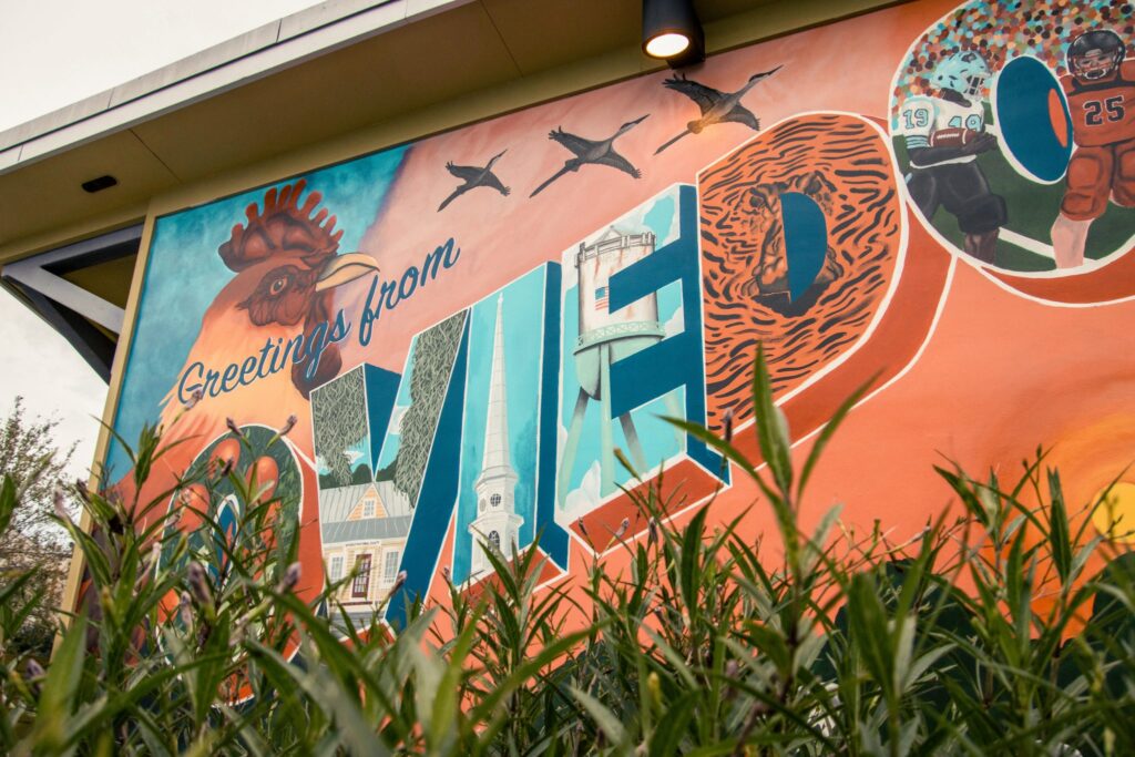City mural that says “Greetings from Oviedo” in Oviedo FL